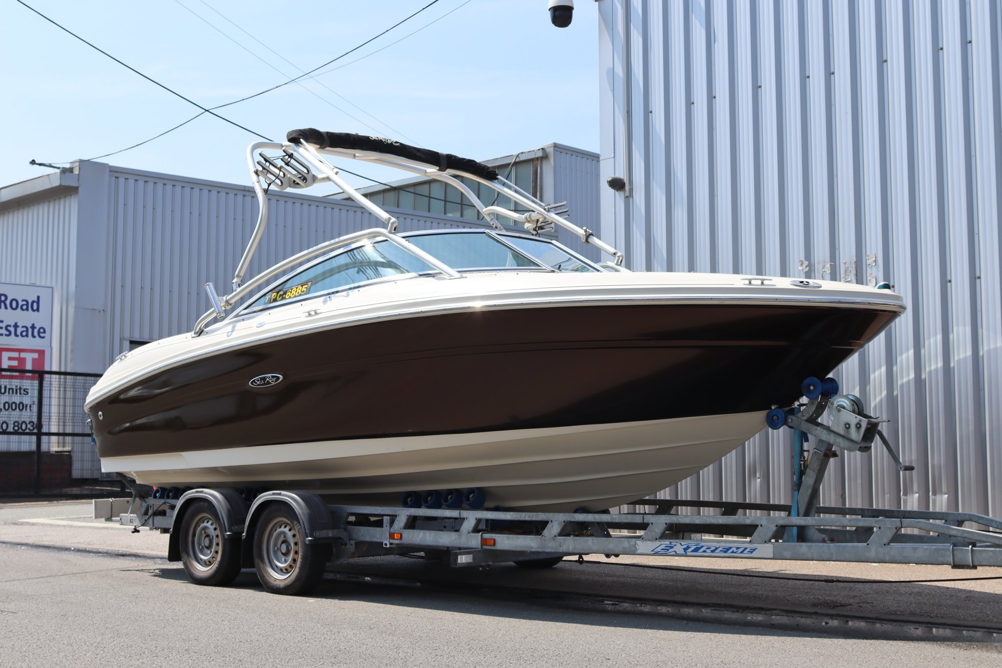 Sea Ray boat on its trailer with a gloss brown vinyl hull wrap, Manchester