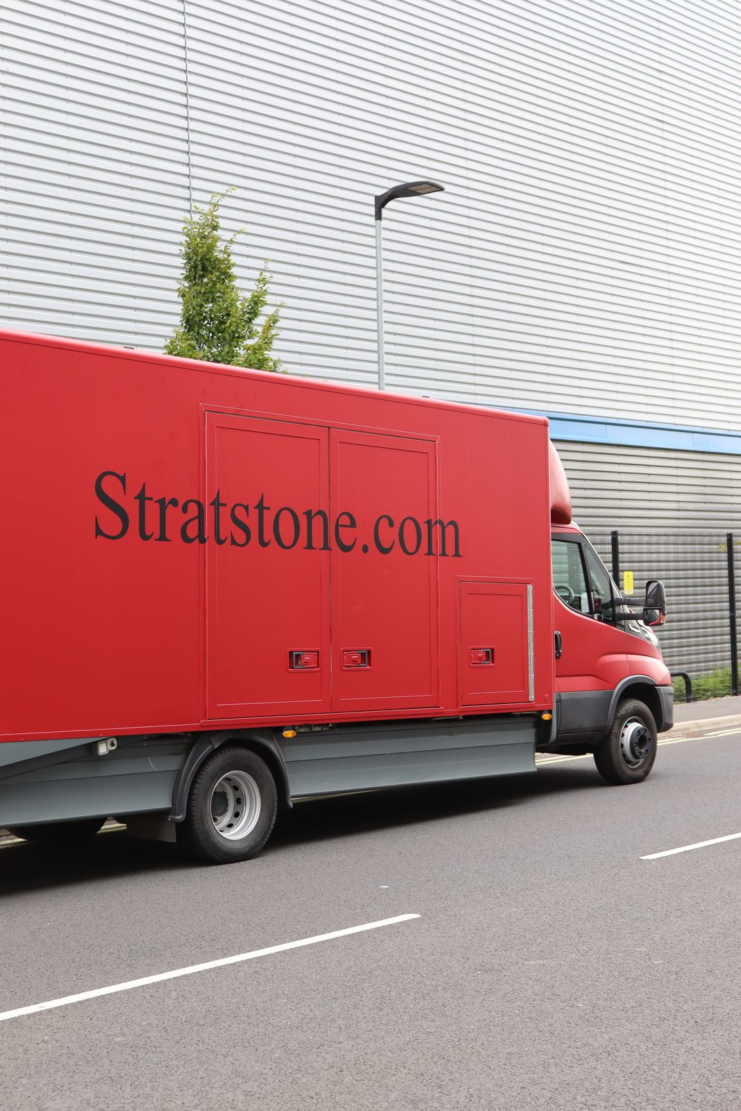 Side view of a Stratstone Iveco box van with printed livery by Auto Wrap Manchester