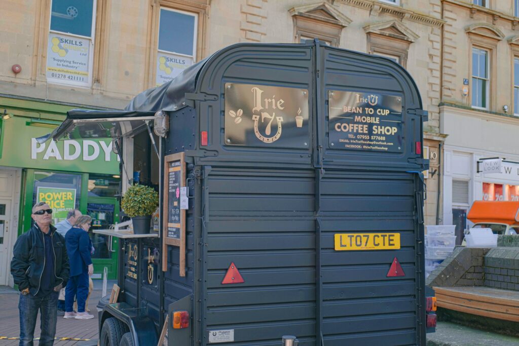 Converted horsebox coffee unit with printed signage trading at a market